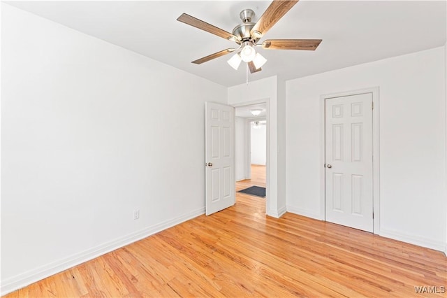 unfurnished bedroom featuring light wood-type flooring, baseboards, and a ceiling fan