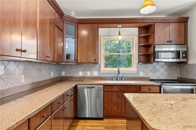 6803 Emerald Ln, Tuscaloosa, AL 35406 - kitchen with stainless steel appliances, a sink, pendant lighting, glass insert cabinets, and tasteful backsplash