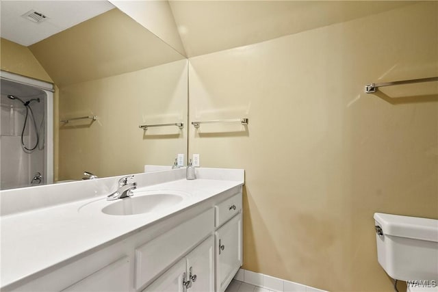 6803 Emerald Ln, Tuscaloosa, AL 35406 - bathroom with vanity, toilet, tile patterned floors, a shower, and lofted ceiling
