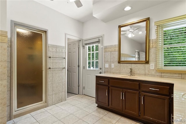 6803 Emerald Ln, Tuscaloosa, AL 35406 - bathroom featuring ceiling fan, vanity, plenty of natural light, tile patterned floors, and tile walls