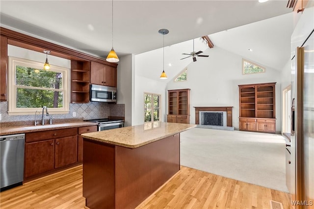 6803 Emerald Ln, Tuscaloosa, AL 35406 - kitchen with appliances with stainless steel finishes, a sink, light wood finished floors, a fireplace with raised hearth, and high vaulted ceiling