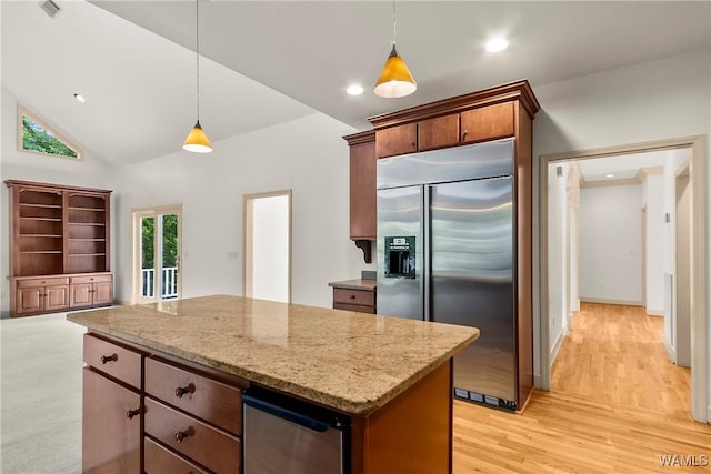 6803 Emerald Ln, Tuscaloosa, AL 35406 - kitchen featuring stainless steel built in fridge, light stone countertops, hanging light fixtures, light wood-style floors, and a kitchen island