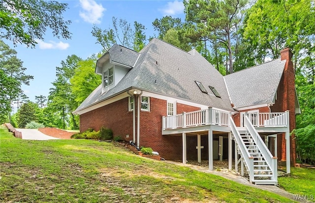 6803 Emerald Ln, Tuscaloosa, AL 35406 - back of house featuring a wooden deck, a chimney, stairs, a shingled roof, and brick siding