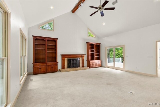 6803 Emerald Ln, Tuscaloosa, AL 35406 - unfurnished living room featuring high vaulted ceiling, a tiled fireplace, beam ceiling, light colored carpet, and a ceiling fan