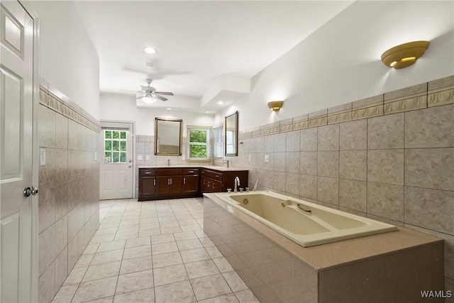6803 Emerald Ln, Tuscaloosa, AL 35406 - full bathroom with tile walls, double vanity, a garden tub, ceiling fan, and tile patterned floors