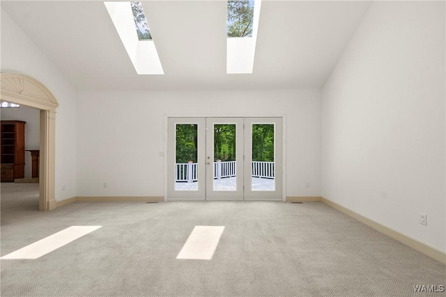 6803 Emerald Ln, Tuscaloosa, AL 35406 - unfurnished room with a skylight, light carpet, lofted ceiling, and baseboards
