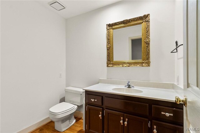 6803 Emerald Ln, Tuscaloosa, AL 35406 - bathroom featuring toilet, vanity, wood finished floors, and baseboards