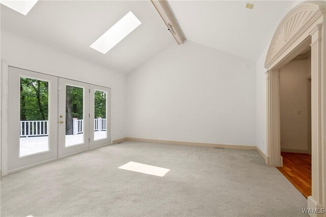 6803 Emerald Ln, Tuscaloosa, AL 35406 - spare room featuring a skylight, baseboards, and light carpet