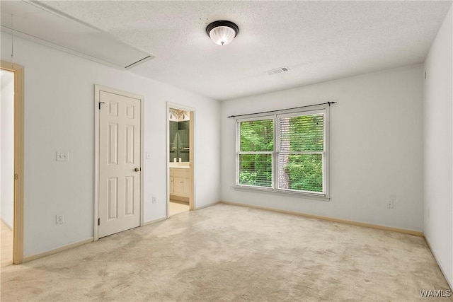 6803 Emerald Ln, Tuscaloosa, AL 35406 - unfurnished bedroom featuring attic access, carpet floors, a textured ceiling, and baseboards