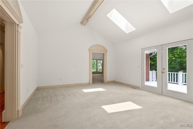 6803 Emerald Ln, Tuscaloosa, AL 35406 - spare room with a skylight, beam ceiling, light colored carpet, baseboards, and french doors