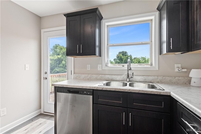 kitchen with sink, dishwasher, and light hardwood / wood-style flooring