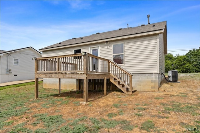 back of house featuring cooling unit and a wooden deck