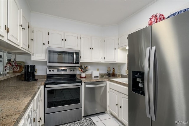 kitchen with tile countertops, white cabinets, and stainless steel appliances