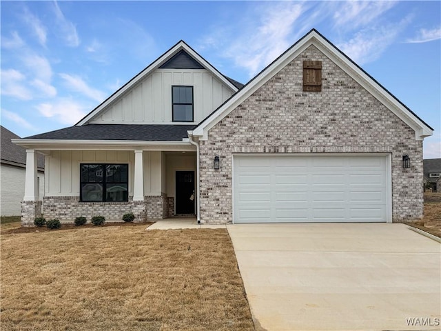 view of front of house with a garage, a front yard, and covered porch