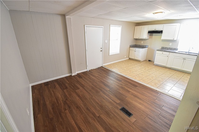 kitchen featuring white cabinets, light hardwood / wood-style floors, a wealth of natural light, and sink