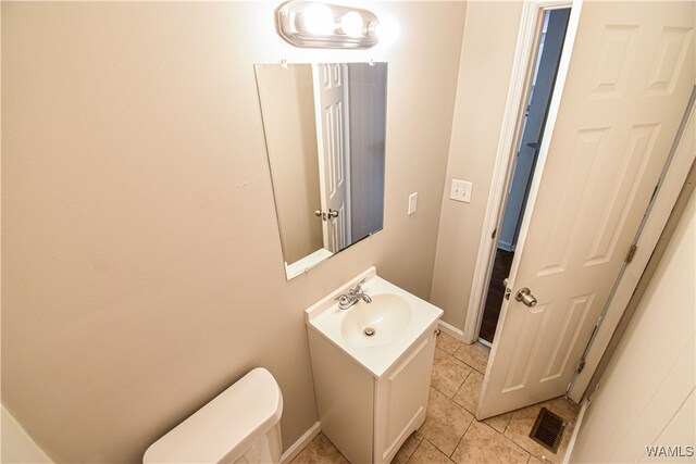 bathroom with tile patterned floors, vanity, and toilet