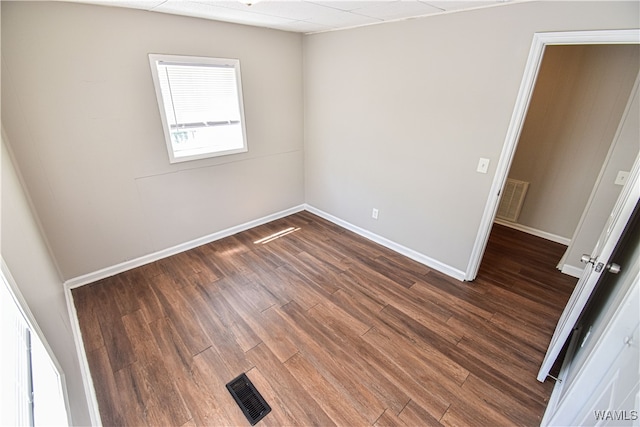 spare room with dark hardwood / wood-style flooring