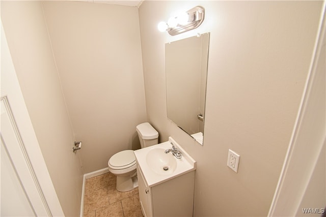 bathroom with tile patterned flooring, vanity, and toilet