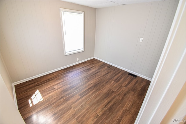 empty room featuring dark hardwood / wood-style floors