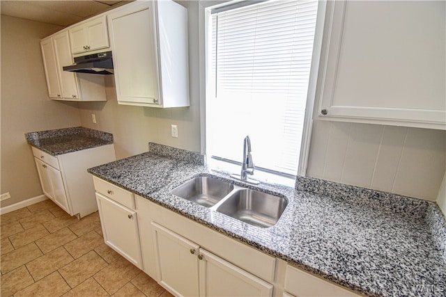 kitchen with white cabinets, a wealth of natural light, and sink