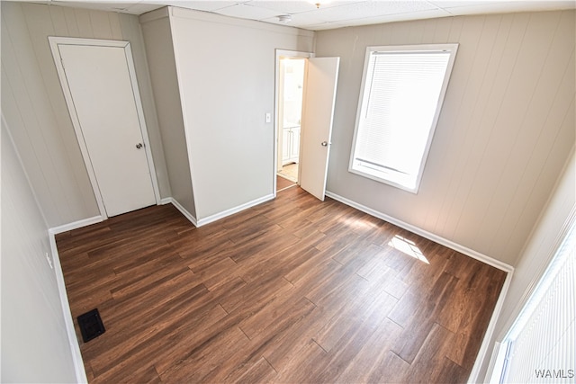 unfurnished room featuring dark wood-type flooring