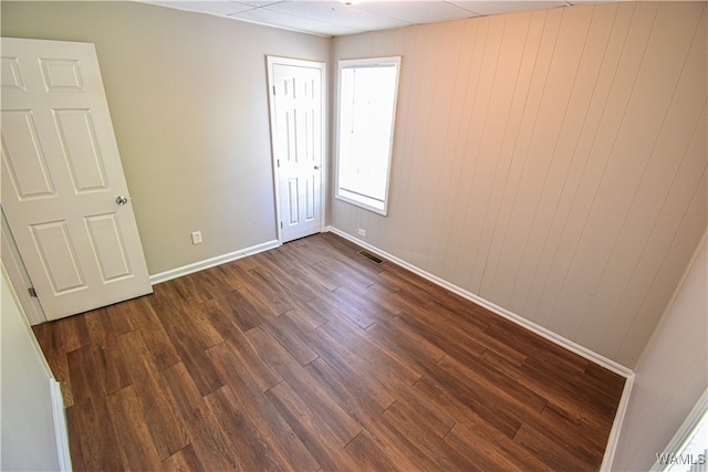 empty room featuring dark wood-type flooring