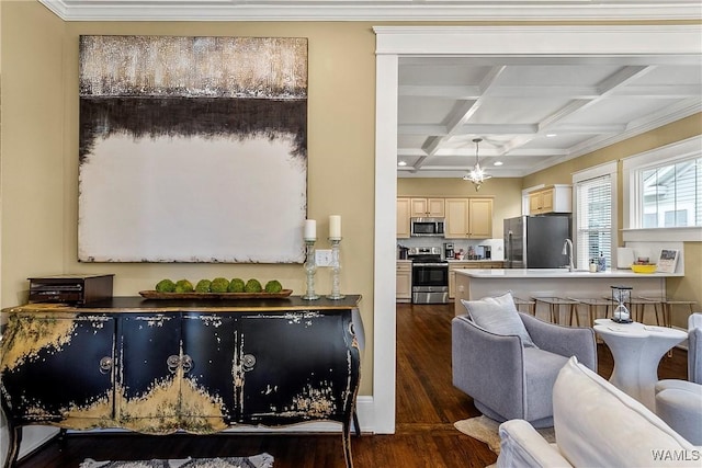 kitchen featuring coffered ceiling, dark wood-style flooring, beamed ceiling, stainless steel appliances, and cream cabinetry