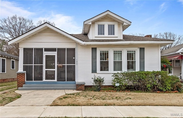 bungalow-style house with a sunroom