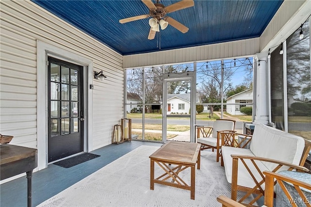 sunroom / solarium featuring ceiling fan