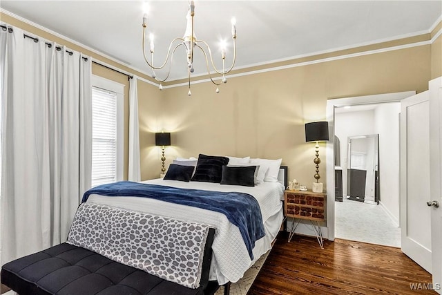 bedroom with an inviting chandelier, baseboards, crown molding, and wood finished floors