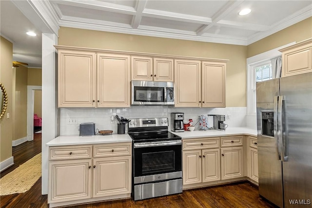 kitchen with stainless steel appliances, light countertops, dark wood finished floors, and cream cabinets