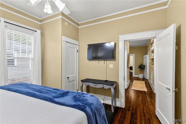 bedroom featuring ornamental molding, wood finished floors, and baseboards