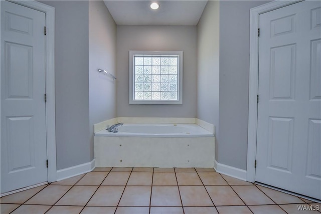 bathroom featuring tile patterned floors and a tub to relax in