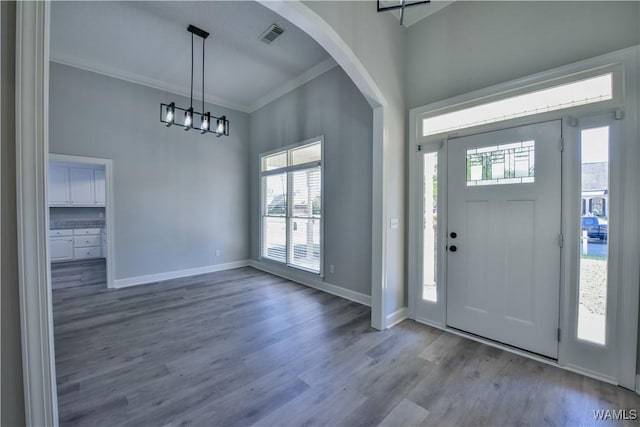 foyer entrance featuring hardwood / wood-style floors and ornamental molding