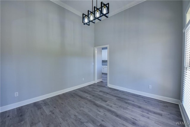 unfurnished room featuring dark hardwood / wood-style floors and ornamental molding