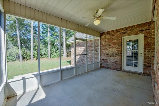 unfurnished sunroom featuring ceiling fan