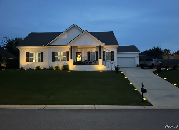 craftsman-style home with a garage, driveway, and a front yard