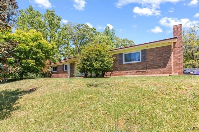 7665 Baptist Campground Rd, Northport, AL 35473 - view of front of property featuring a chimney, brick siding, and a front yard