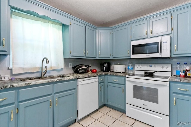 7665 Baptist Campground Rd, Northport, AL 35473 - kitchen featuring light tile patterned floors, a sink, white appliances, a textured ceiling, and blue cabinetry