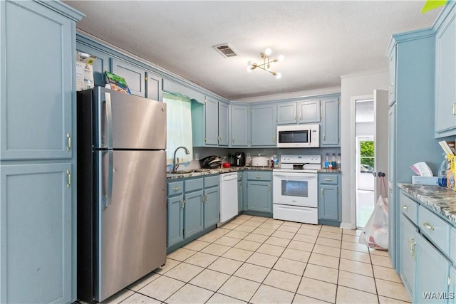 7665 Baptist Campground Rd, Northport, AL 35473 - kitchen featuring a sink, white appliances, light tile patterned floors, blue cabinetry, and visible vents