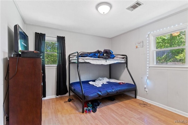 7665 Baptist Campground Rd, Northport, AL 35473 - bedroom with wood finished floors, visible vents, crown molding, and multiple windows