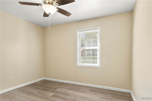 empty room with ceiling fan and light hardwood / wood-style floors