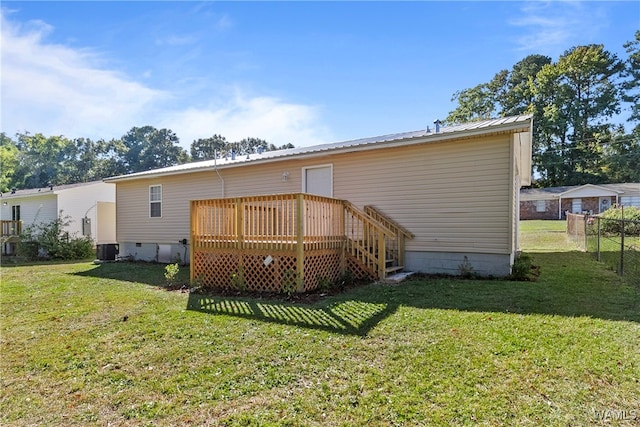 back of property with a yard, central AC, and a wooden deck