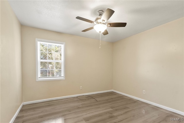 unfurnished room featuring ceiling fan, a textured ceiling, and light hardwood / wood-style flooring