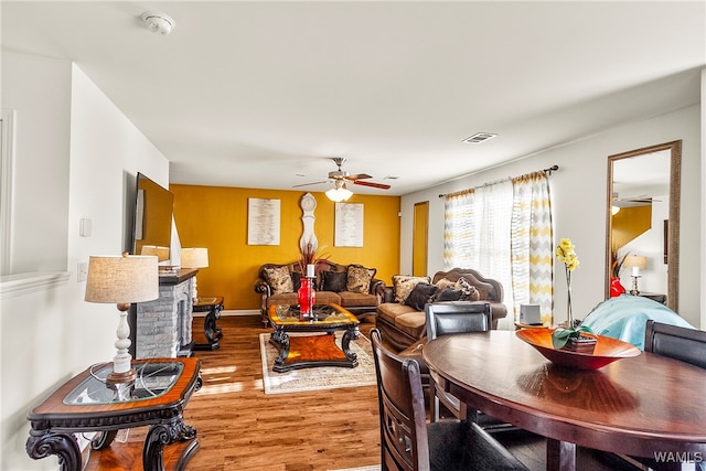 living room featuring hardwood / wood-style flooring and ceiling fan