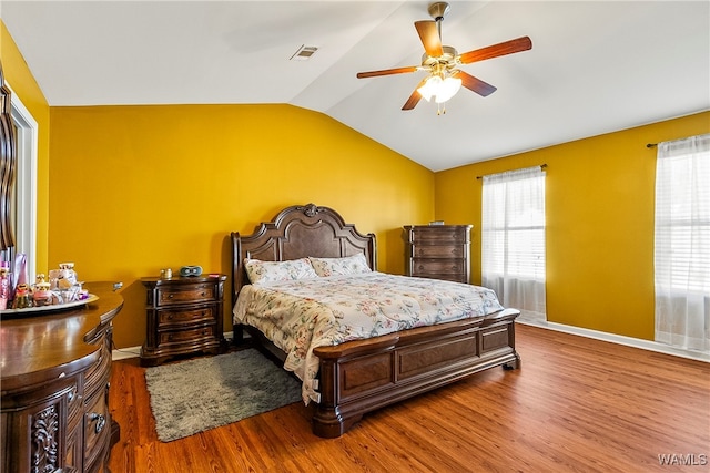 bedroom featuring hardwood / wood-style floors, vaulted ceiling, and ceiling fan