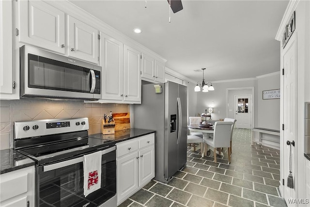 kitchen featuring stainless steel appliances, white cabinets, crown molding, and tasteful backsplash