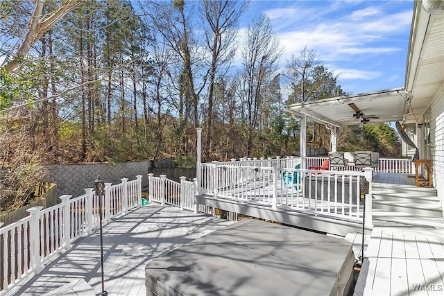 wooden terrace with a ceiling fan and fence