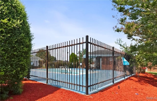 view of gate featuring a fenced in pool and fence