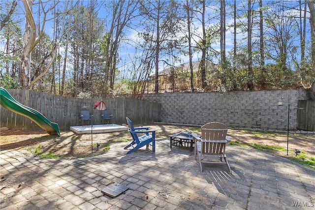 view of patio / terrace featuring a fenced backyard and a playground